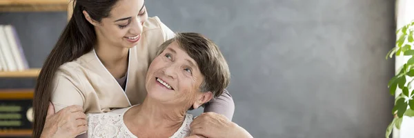 Panorama Cuidador Amigável Abraçando Uma Mulher Idosa Hospício — Fotografia de Stock