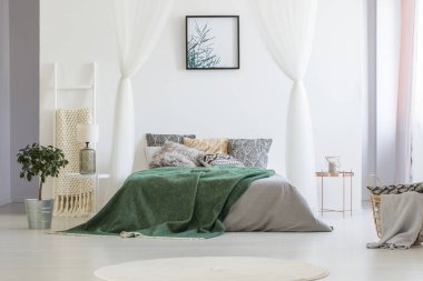 Yeşil Paket Çift Kişilik Yatak birçok yastıklar ve gri yaprak beyaz otel odası iç duvar, zemin ve cam lamba başucundaki bitkiye basit posteri ile ayakta ile atılmış