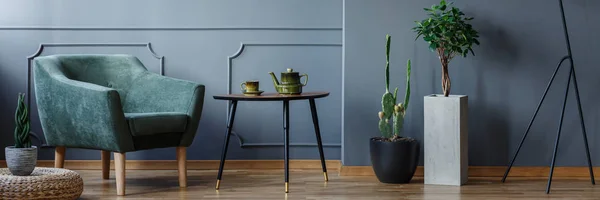 Small Table Jug Tea Cup Standing Next Green Armchair Dark — Stock Photo, Image