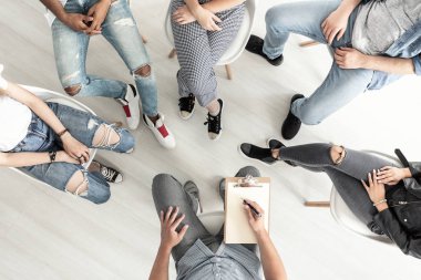 Top view of a group therapy session for teenagers struggling with depression clipart