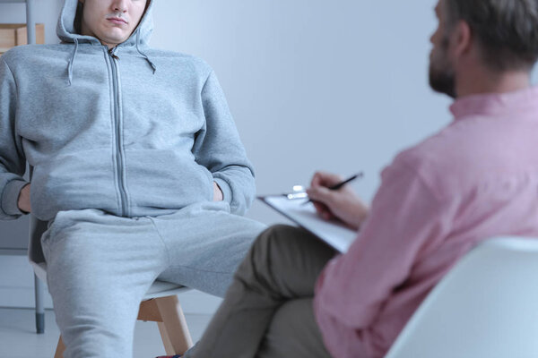 Juvenile offender talking to his curator during a meeting