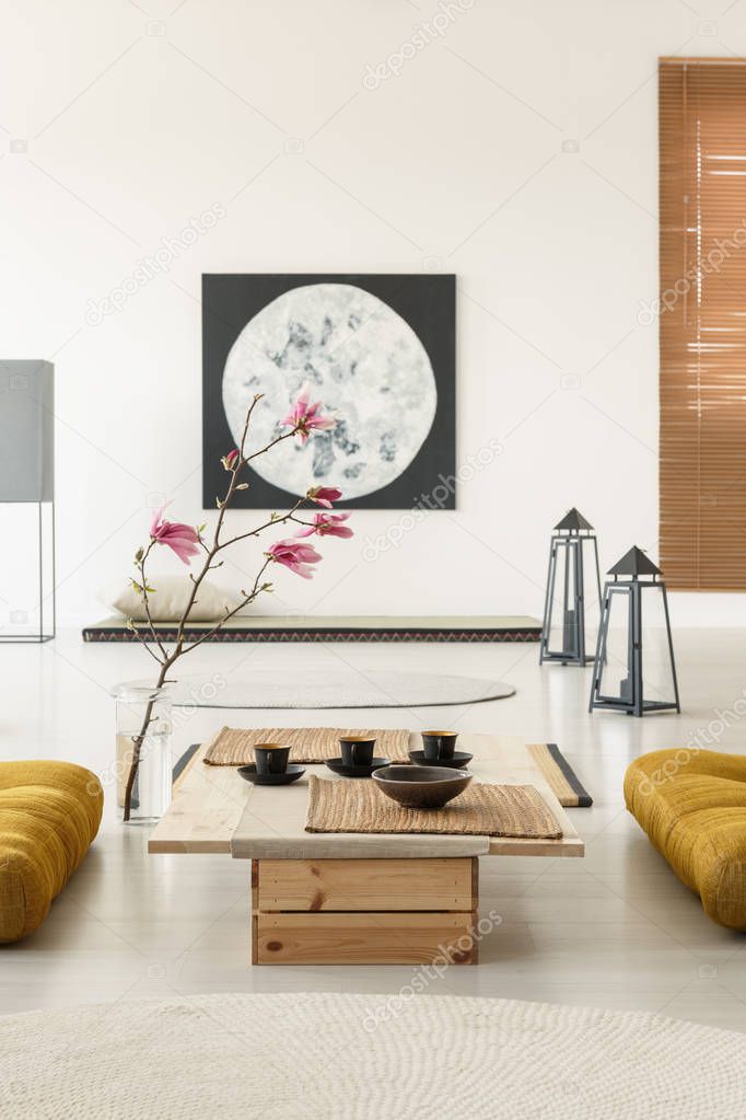 Real photo of a japanese room interior with tatami mats, table, flowers and big moon poster