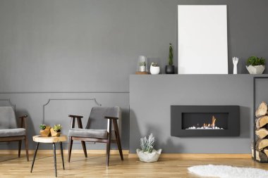 Şömine boş poster gri oturma odası iç koltuklar ile mockup ile altında. Gerçek fotoğraf