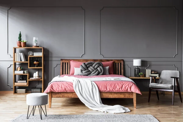 Grey Armchair Next Pink Wooden Bed Minimal Bedroom Interior Pouf — Stock Photo, Image