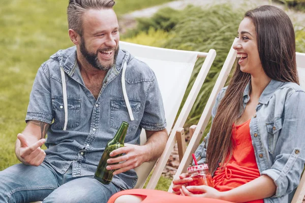 Happy and smiling couple enjoying meeting during outdoor party