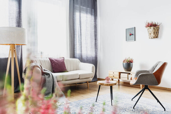 Modern living room interior with white sofa and grey armchair