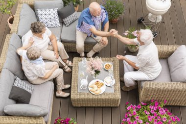 Top view on senior people talking during meeting on the terrace of a nursing house clipart