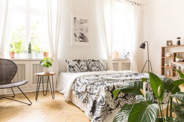 Yaprak motifi keten arka duvarı içinde pencere eşiği ile modern yatak odası iç büyük bir yatağa. Gerçek fotoğraf.