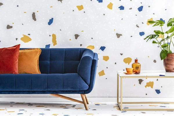 枕头在蓝色沙发旁边在桌与植物在多彩的现代客厅内部 真实照片 — 图库照片