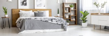 Scandinavian style, wooden furniture in a stylish, monochromatic bedroom interior with plants, gray walls and industrial elements clipart