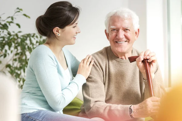 Happy Woman Supporting Smiling Senior Man Walking Stick — Stock Photo, Image