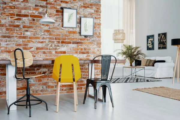 Cadeiras Mesa Contra Parede Tijolo Vermelho Com Cartazes Interior Apartamento — Fotografia de Stock