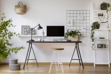 Saç tokası dışkı ayakta mockup bilgisayar ekranı, metal lamba ve gerçek fotoğraf kahve fincan beyaz ev ofis iç ahşap masası tarafından