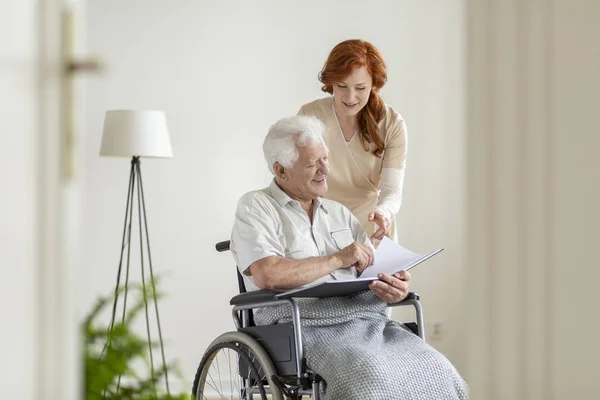 Nurse Patient Wheelchair Looking Photo Album Together Smiling — Stock Photo, Image