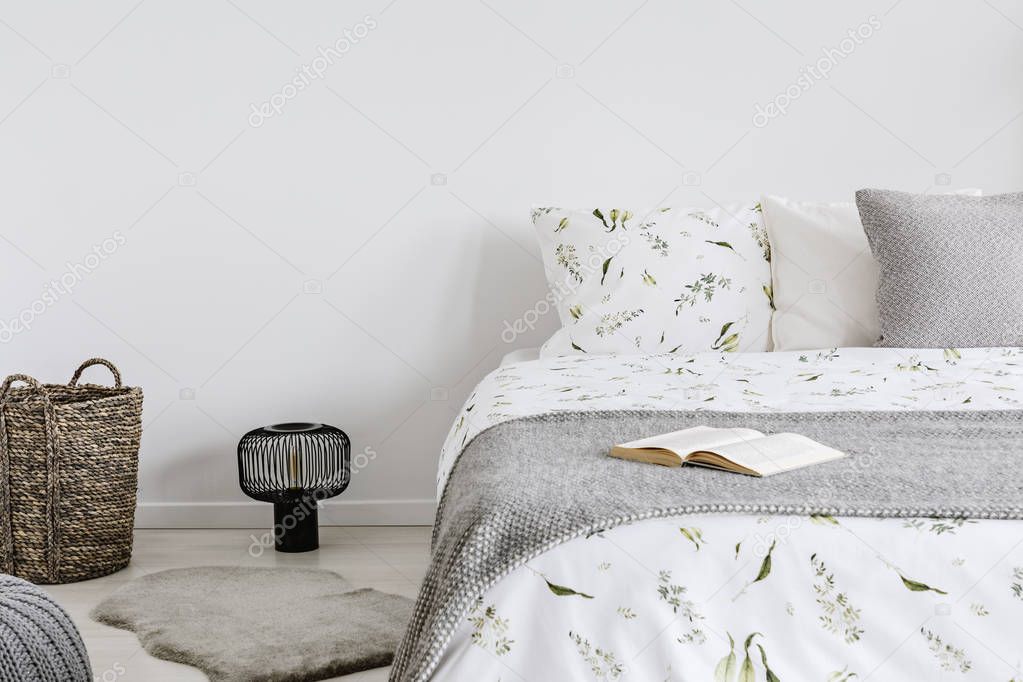 close-up of a bed with eco cotton and wool bedding and pillows in a bright bedroom interior. Real photo.
