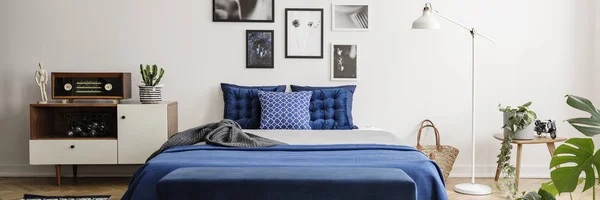 真实照片的蓝色床 复古橱柜 艺术画廊和灯在卧室内 — 图库照片