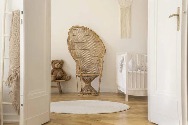 Weidenpfauenstuhl Steht Weißen Babyzimmer Interieur Mit Kinderbett Teddybär Und Rundem — Stockfoto