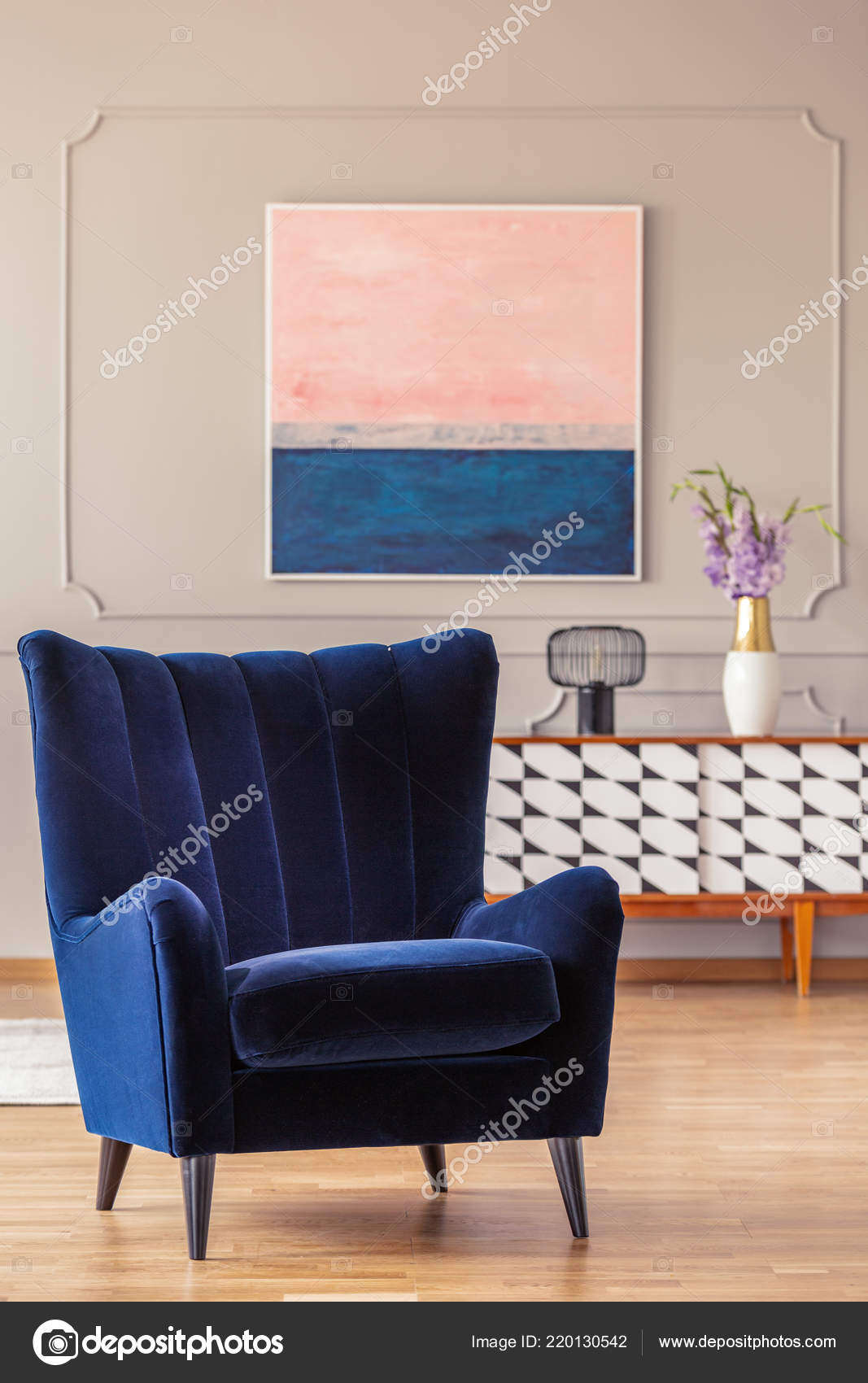 retro navy blue armchair in an elegant living room interior with an  abstract painting on a wall with molding 220130542