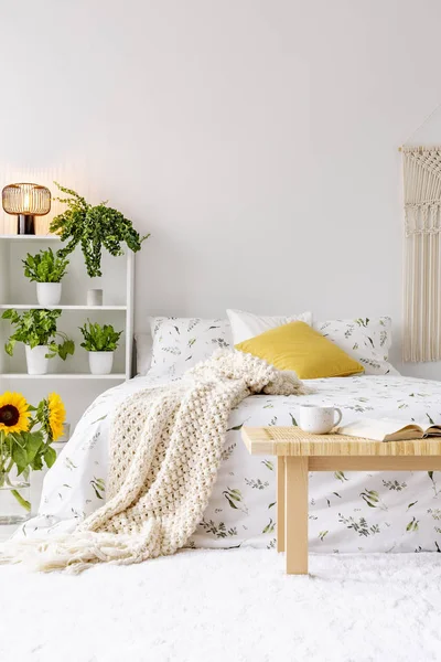 阳光明媚的春天卧室内饰与绿色植物旁边一张床上穿着生态棉床单 黄色的口音 空白的白色背景墙 真实照片 — 图库照片