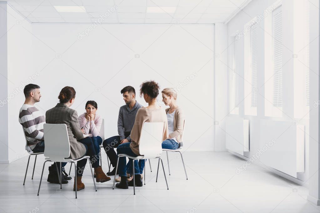 Group psychotherapy in white interior
