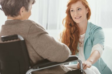 Açık mavi üniforma genç doktor ile hasta üst düzey hastasını hastanede