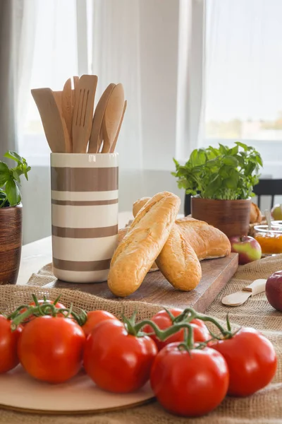 Wooden Spoons Container Next Baguettes Dining Table Tomatoes Real Photo — Stock Photo, Image