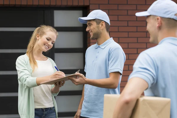 Two Friendly Couriers Girl Signing Form — Stock Photo, Image