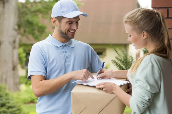 Happy Courier Blue Uniform Woman Signing Receipt Package Delivery — Stock Photo, Image