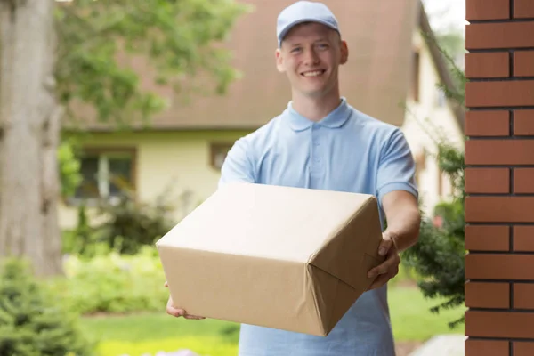 Happy Young Courier Blue Uniform Holding Package — Stock Photo, Image