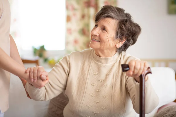 Caregiver Holding Hand Smiling Senior Woman Walking Stick — Stock Photo, Image