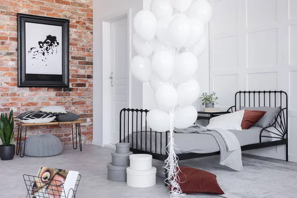 Stylish bedroom interior with grey bedding and bunch of white balloons, real photo — Stock Image Stylish Bedroom Interior Grey Bedding Bunch White Balloons Real Photo Stock Picture