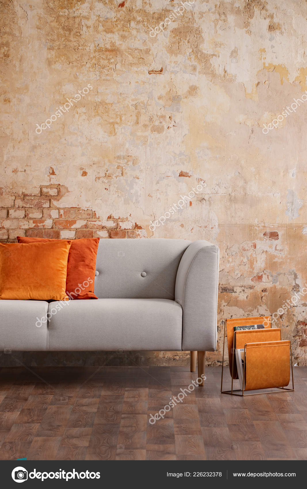 grey couch with orange pillows
