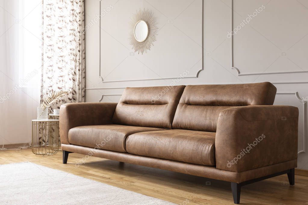 Real photo of a leather couch in a living room interior