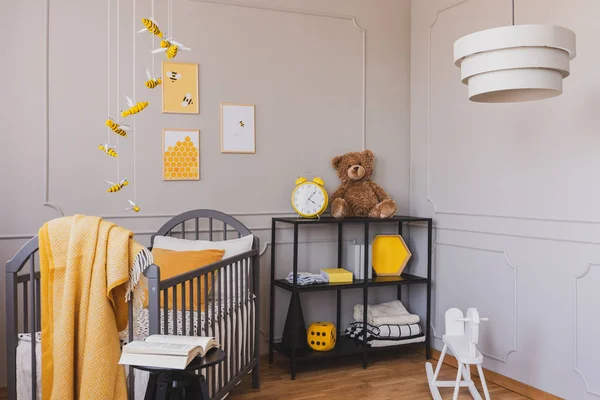 在时尚婴儿卧室的工业货架上的泰迪熊和黄色时钟 — 图库照片