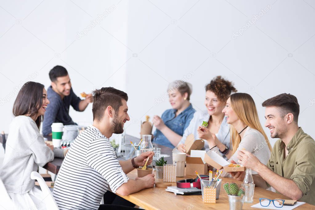 Friends and coworkers during lunch brake at modern marketing firm