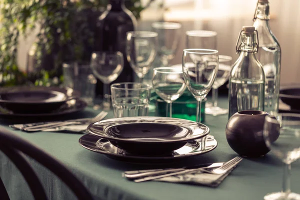 Closeup Elegant Dining Table Green Tablecloth Black Plates Wine Glasses — Stock Photo, Image