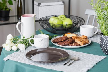 Plaka tanımlama bilgilerini, kahve bardağı ve tablo tabaklarda yanındaki yeşil elma ile şık Yaylası