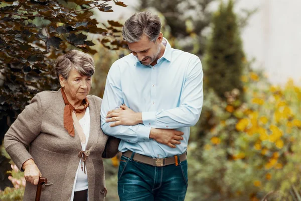 Worried Grey Senior Lady Walking Cane Garden Her Son — Stock Photo, Image