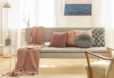Colorful pillows and blanket on comfortable grey couch