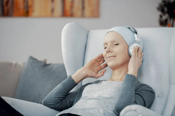 Peaceful Woman Headphones Blue Headscarf Sitting Comfortable Armchair Resting Home — Stock Photo, Image