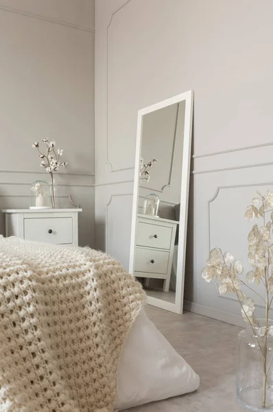 Mirror in white frame on grey wall of stylish scandinavian bedroom interior — Stock Photo, Image