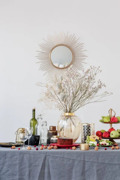 Szklany wazon z kwiatami w środku jadalni stół z jedzeniem i owoce — Zdjęcie stockowe
