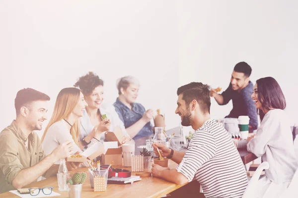 Friends from work eating their delivered lunch at the office desk during lunch break at corporation — Stock Photo, Image