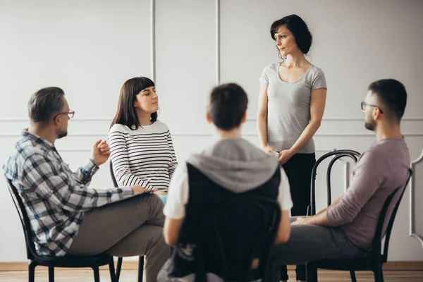 Verontruste vrouwen luisteren naar pshychologist tijdens ondersteuning groep vergadering — Stockfoto