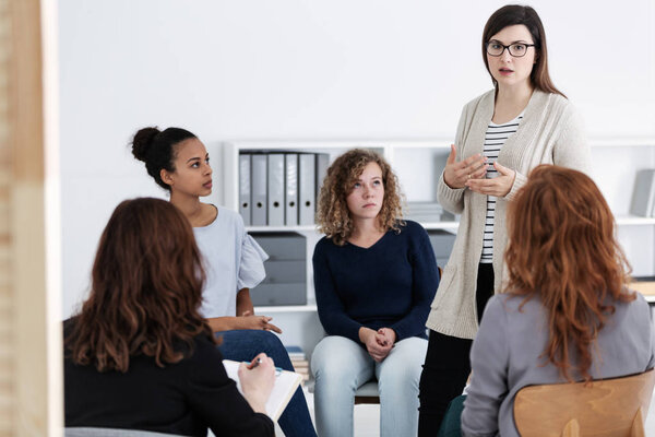 women supporting each other during psychotherapy group meeting