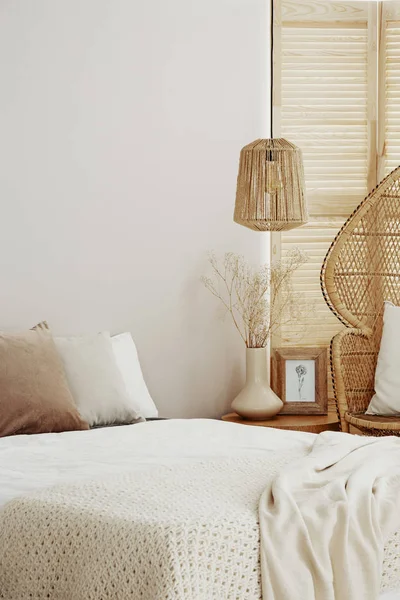 Rattan żyrandol nad łóżkiem w naturalnej sypialni, Kopiuj przestrzeń na pustej ścianie — Zdjęcie stockowe