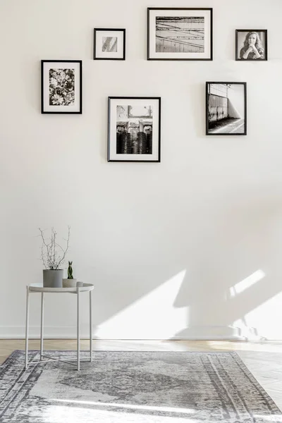 Interior vacío de la sala de estar con mesa de café, alfombra y carteles en el suelo — Foto de Stock