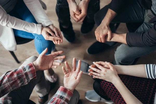 Shot from above of people's hands during psychoterapy group session — Stock Photo, Image