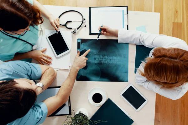 Vue de dessus de la réunion du jeune médecin professionnel au cours d'un examen radiographique au cabinet médical — Photo