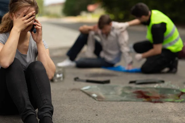 Female driver guilty of car accident sitting on the road — Stock Photo, Image